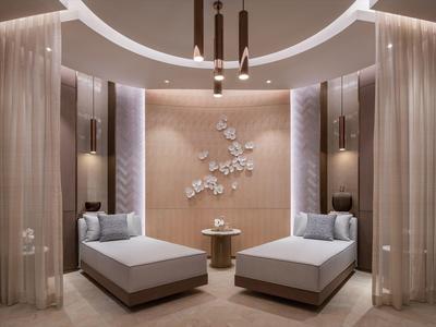 Elegant relaxation room with two loungers, wall plant art, and soft lighting.
