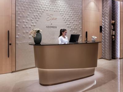 Reception desk with receptionist in a modern hotel interior.