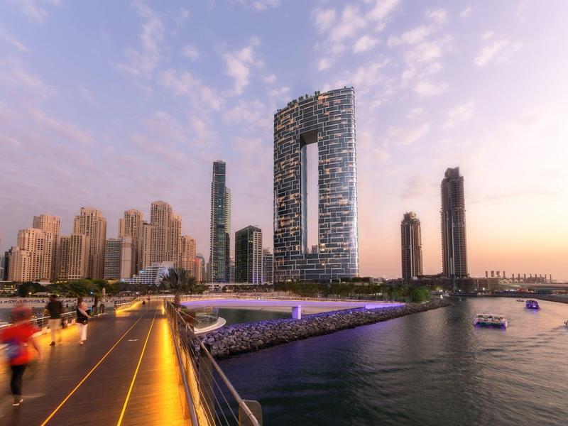 Elegant relaxation room with two loungers, wall plant art, and soft lighting.