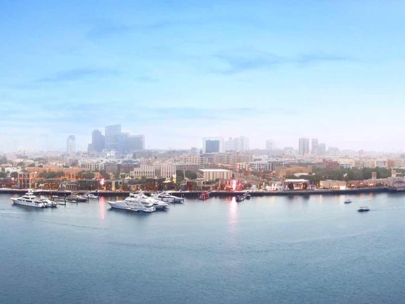 Panoramic view of a coastal city with boats and clear sky