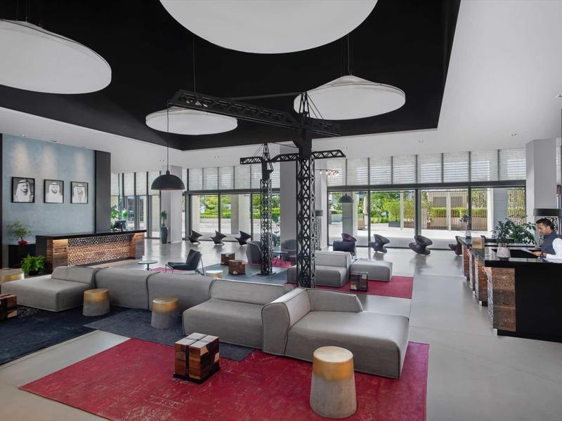 Modern spacious hotel lounge with stylish furniture and large windows