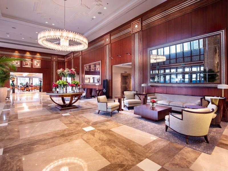Elegant hotel lobby with chandeliers, comfortable seating, and luxurious interior design.