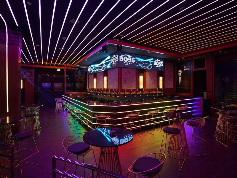Modern bar with neon-lit counter and stylish seating in a hotel
