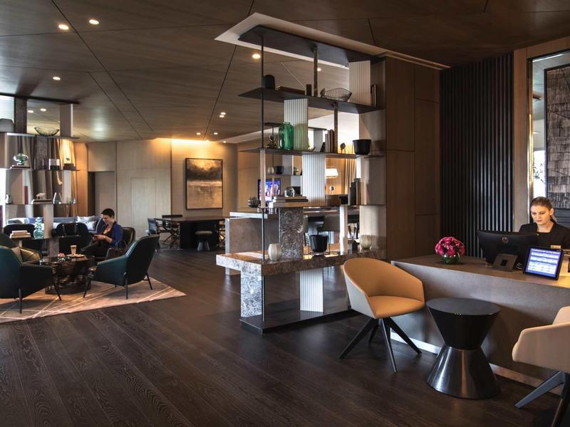 Modern hotel lobby area with seating groups and stylish lighting.