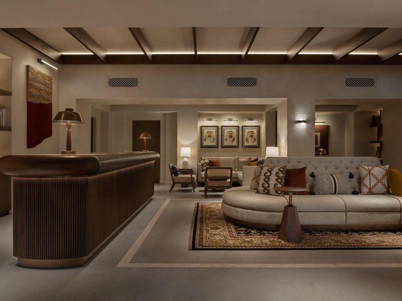 Elegant hotel lounge furniture with warm lighting and modern artwork on the walls.