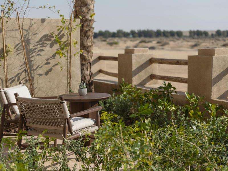 Cozy seating area with plants overlooking the vast landscape.