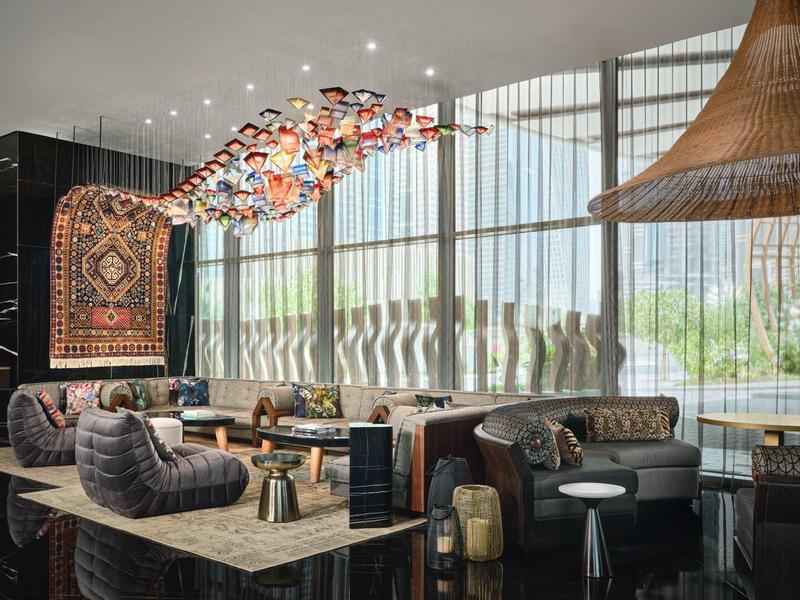 Modern hotel lounge area with large windows and stylish seating arrangements.