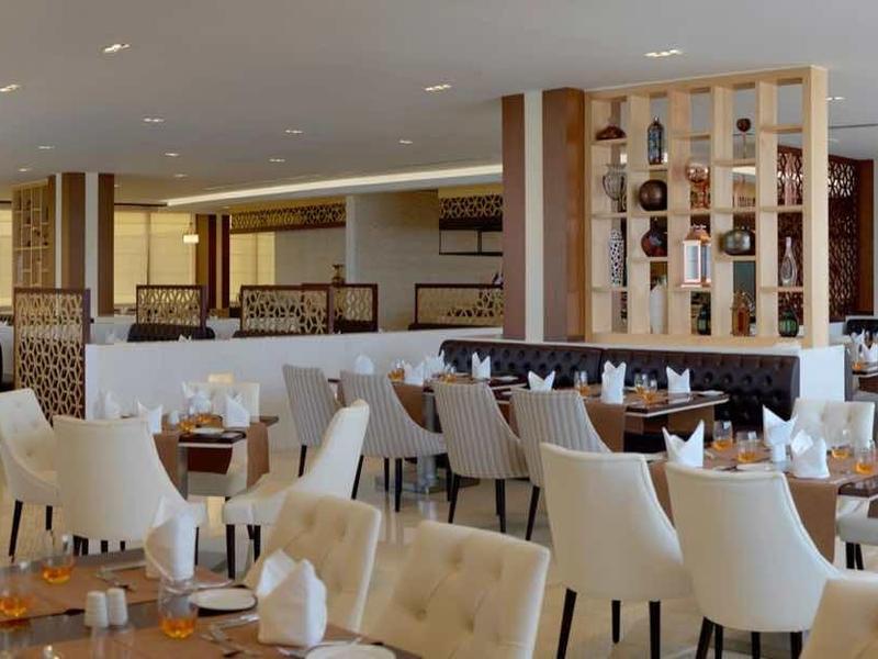 Amplio salón de restaurante con mesas elegantes y muebles modernos de madera.