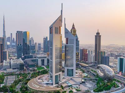 Modern Dubai skyline with iconic skyscrapers at sunset.