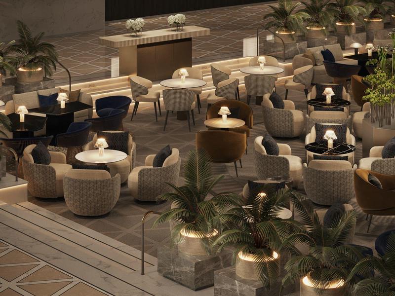 Modern outdoor restaurant with wicker chairs and plants in subdued lighting.