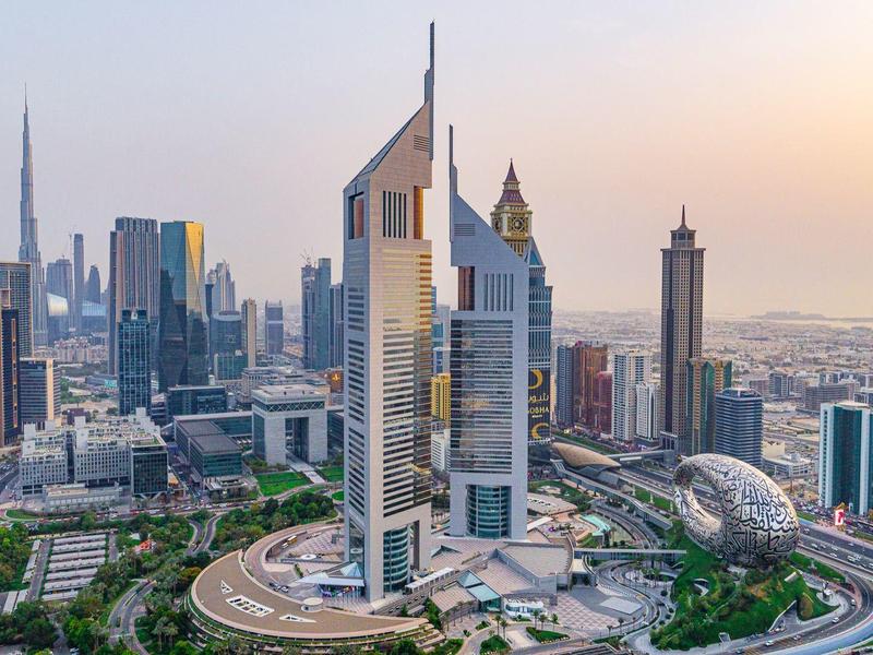 Modern Dubai skyline with iconic skyscrapers at sunset.