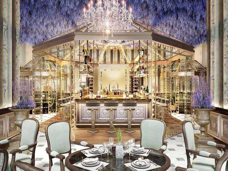Elegant restaurant interior with chandelier, ornate walls, and stylishly set tables.