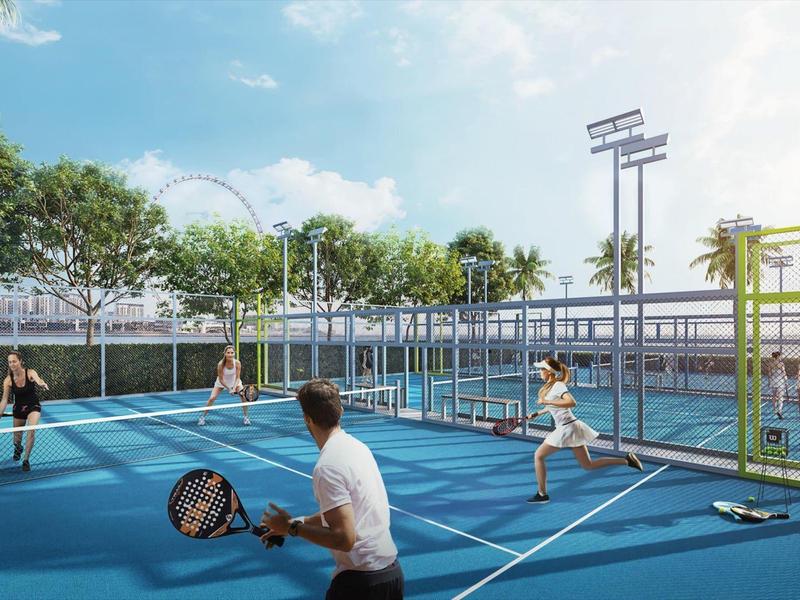 Four people playing padel on a blue outdoor court during daylight.