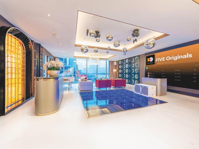 Modern hotel lobby area with seating, glass floor, and Amazon Prime Originals logo.