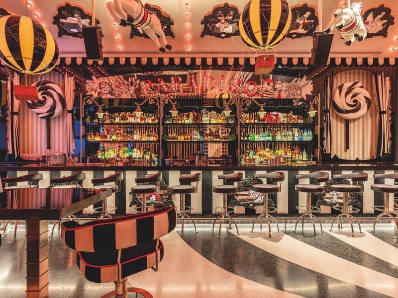 Bar with colorful striped design, hot air balloons, and candy-themed decorations