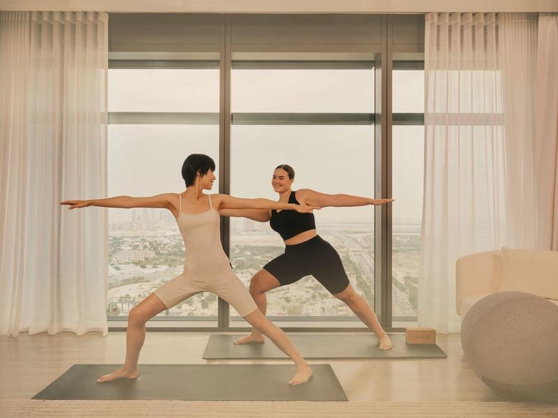 Cozy hotel dining area with wooden furniture and view through window blinds.