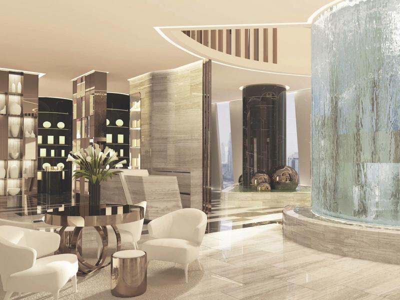 Luxurious hotel lounge with modern glass waterfall and stylish seating areas.