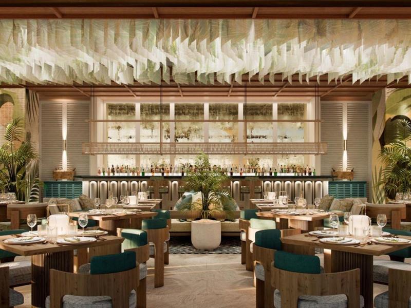 Elegant restaurant with modern furniture and decorative plants.