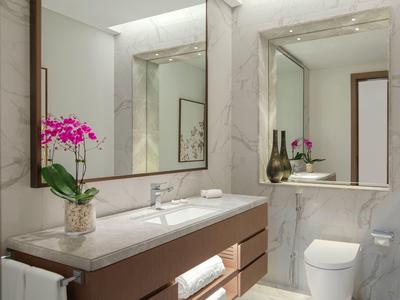 Modern bathroom with white marble walls, wooden furniture, and an orchid on the counter.