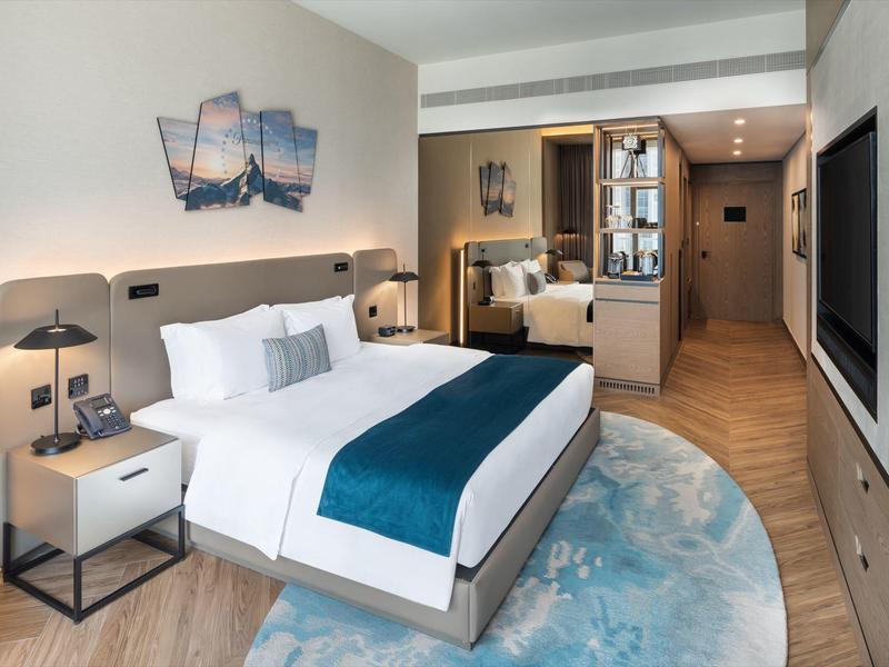 Modern hotel room with comfortable double bed and stylish decor.