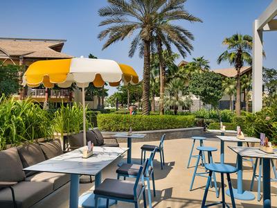 Terrace with modern furniture and umbrella in tropical hotel setting