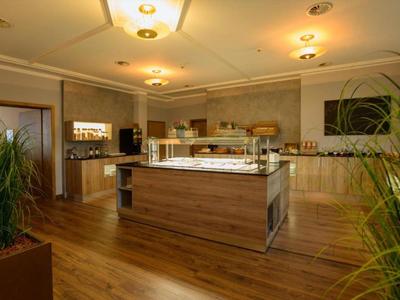 Modern breakfast room with buffet and wooden flooring.