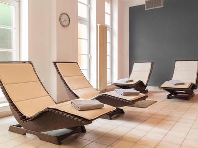 Cozy relaxation room with modern lounge chairs and large windows.