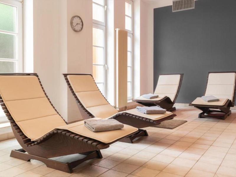 Cozy relaxation room with modern lounge chairs and large windows.