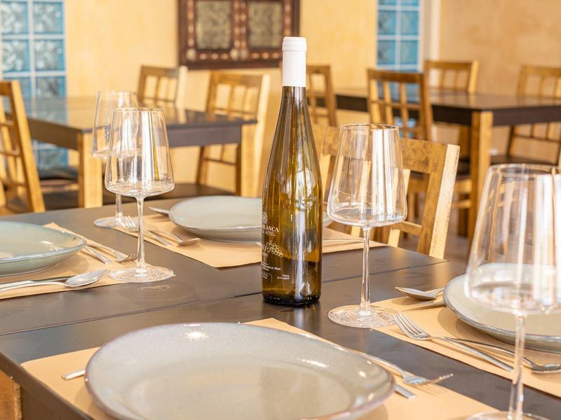 Elegant set table with wine glass and bottle in a restaurant.