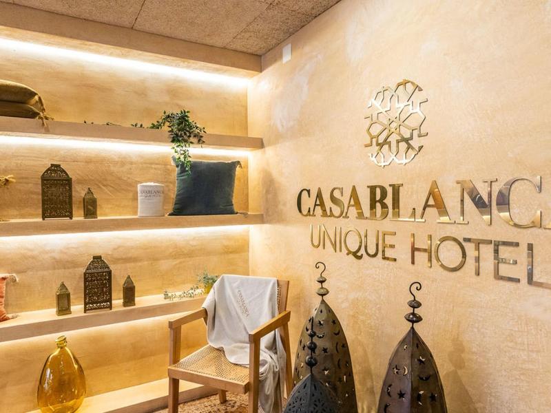 Elegant hotel lobby with chairs, decorations, and illuminated CASA BLANCA sign.