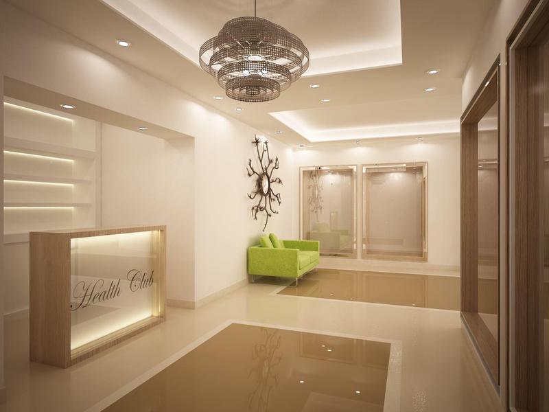 Moderner Empfangsbereich mit beleuchtetem Tresen und grünem Sitzmöbel in hellem Design.