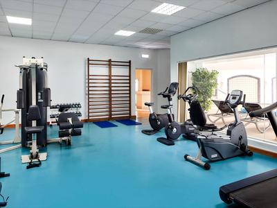 Palestra ben illuminata con attrezzature moderne e ampie finestre