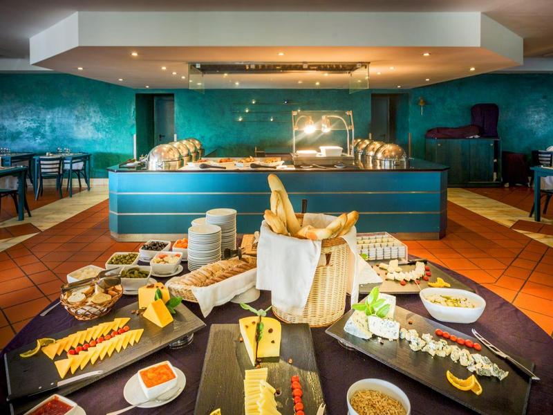 Bufet śniadaniowy z serami, pieczywem i dżemami w restauracji hotelowej.