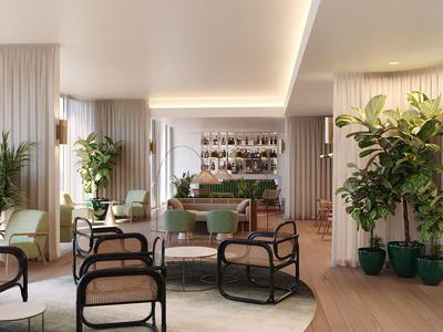 Heller, moderner Loungebereich mit grünen Pflanzen, bequemen Sesseln und warmem Holzboden.