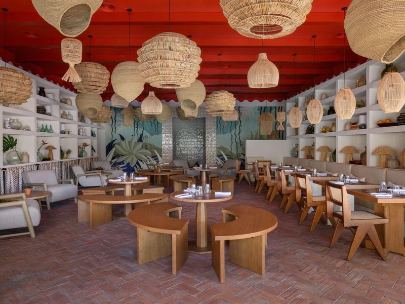 Restaurant moderne avec meubles en bois et nombreuses lanternes suspendues au plafond