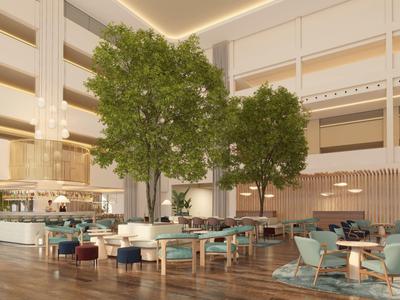 Hall d'hôtel moderne avec de grands arbres, des espaces de sièges et un éclairage chaud.