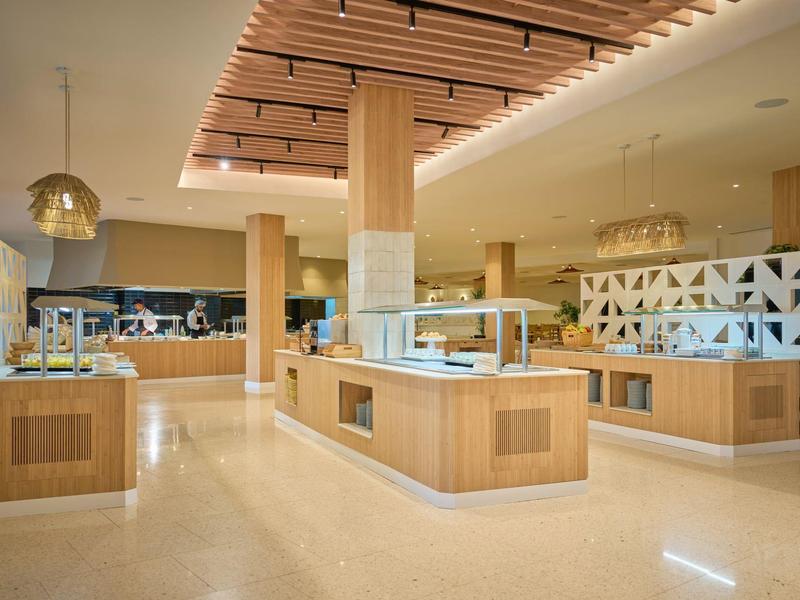Helles Buffetrestaurant mit Holzverkleidung und modernen Deckenakzenten.