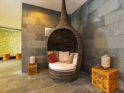 Fauteuil suspendu moderne avec coussins dans un salon de bien-être élégant.