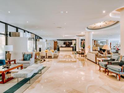 Bright and spacious hotel lobby area with modern furnishings and seating areas