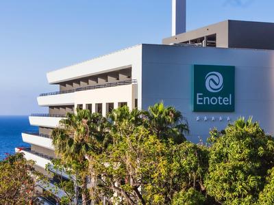 Modern hotel reception area with wooden elements and stylish ceiling lighting