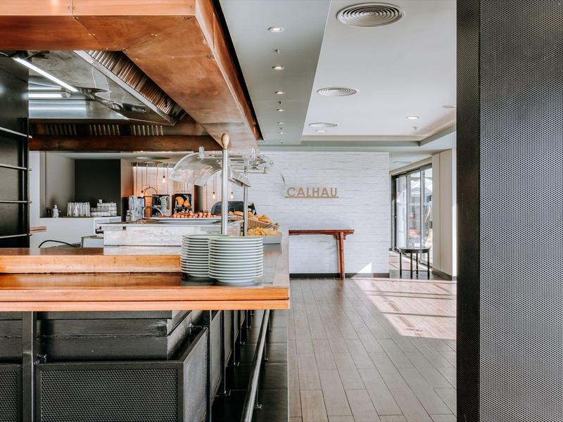 Modern reception area with wooden counter and open access to a bright room