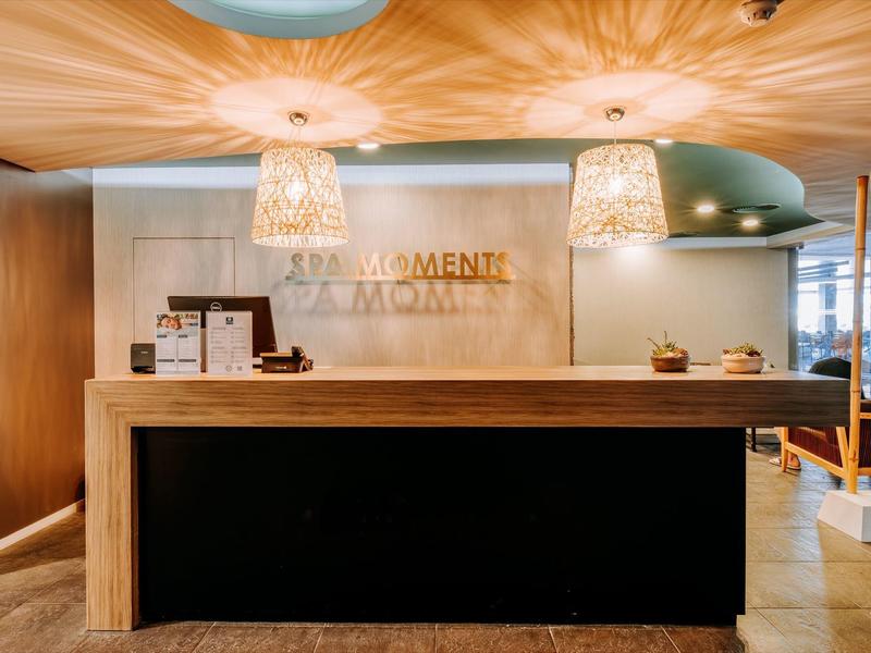 Modern hotel reception area with wooden elements and stylish ceiling lighting