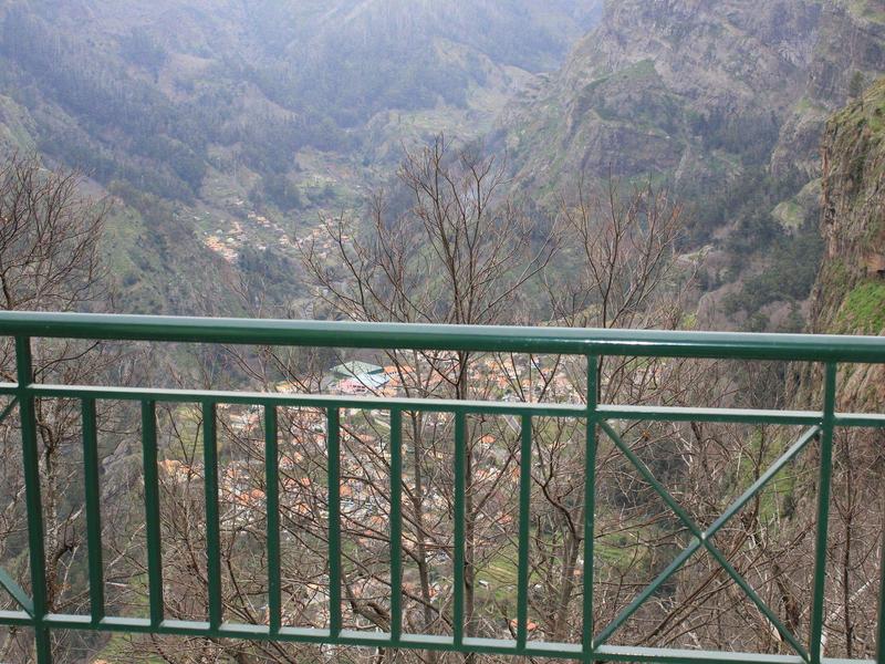 Modern gym with equipment and panoramic mountain views through large windows.