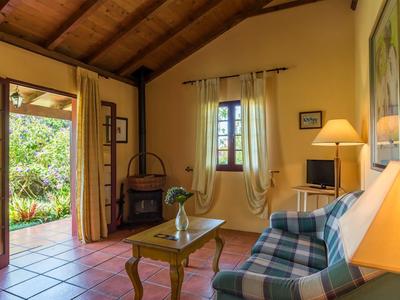 Cozy living room with wooden beam ceiling and garden view