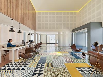 Large hotel lobby with patterned floor, seating area, and reception desk.