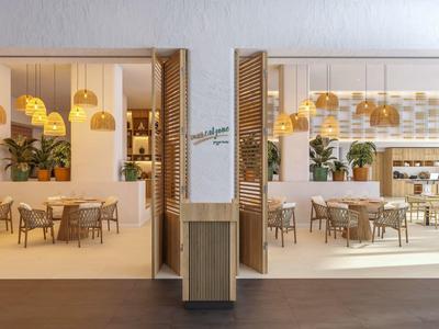 Modern, helder restaurant met houtdecoratie, planten en hanglampen.