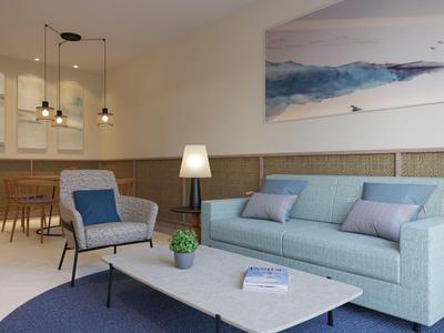 Modern living room with light blue sofa, armchair, pendant lamps, and a scenic wall painting.