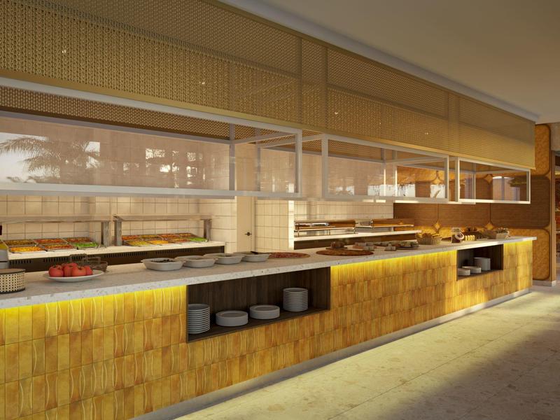 Modern hotel buffet with warm lighting and neatly arranged dishes under glass covers.