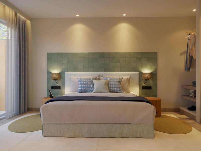 Modern hotel room with a large bed, soft lighting, and a spacious sliding door to the balcony.