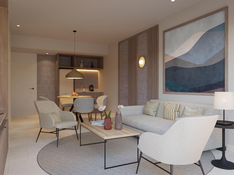 Modern hotel suite with cozy seating area, neutral tones, and stylish decor in a relaxing atmosphere.